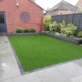 Simple low maintenance sandstone paving and artificial grass